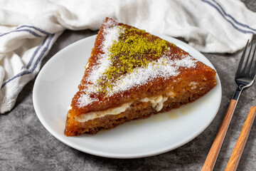 Bread kadayif dessert with cream on a dark background. Turkish cuisine desserts. close up