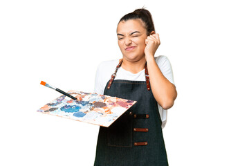 Young artist woman holding a palette over isolated chroma key background frustrated and covering ears