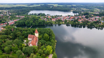 Obraz premium Aerial view of the old town aerial view over green forest with river in the morning. summer background of Lubniewice, poland.