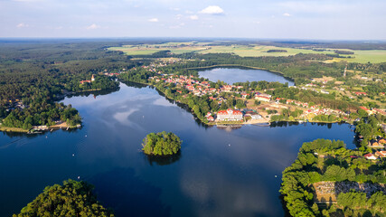 Fototapeta na wymiar Aerial view of the old town aerial view over green forest with river in the morning. summer background of Lubniewice, poland.