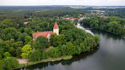 Fototapeta na wymiar Aerial view of the old town aerial view over green forest with river in the morning. summer background of Lubniewice, poland.