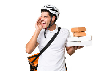 Young caucasian man with thermal backpack over isolated background shouting with mouth wide open to the side