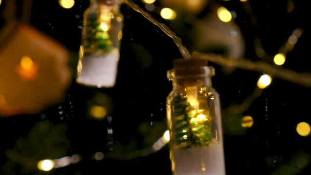 christmas garland on the tree at night. selective focus.