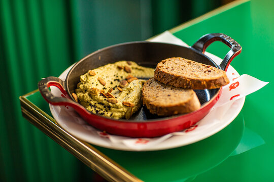 Hummus with baked bread and nuts