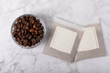 Drip coffee bag and coffee beans, ground coffee for brewing in a cup, paper bag drip coffee filter...