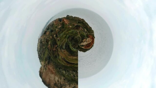 360 degrees of Equirectangular to Stereographic Panorama.
Ocean water fast moving. Beautiful view of sunset in rocky hills on the sea. Spherical projection. Loop rotate.