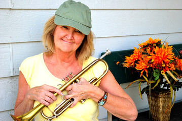 Female trumpet player expressions with her horn outside.