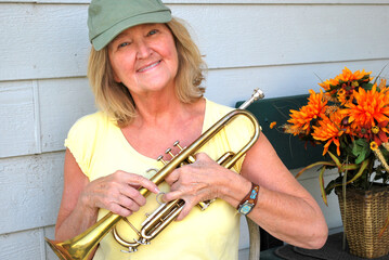 Female trumpet player expressions with her horn outside.