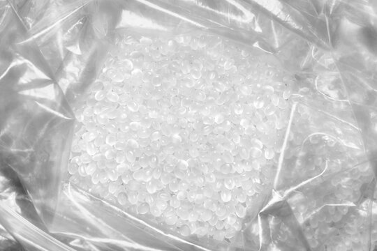 Close up picture of polypropylene granules in a plastic bag, selective focus.