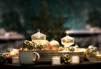 Beautiful holiday decorated table set, golden elegant tableware. Christmas eve.