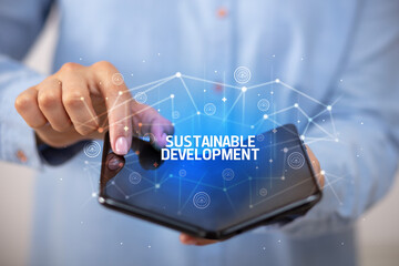 Businessman holding a foldable smartphone, new technology concept