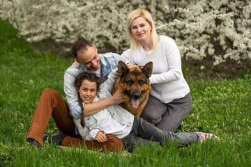 Young family with children and with dog having fun in nature