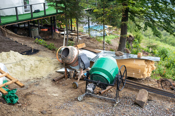 Building wooden materials next to house. Process of building wooden house. Construction of frame house. Lumber at construction site. Concept - sale of lumber for construction. Sale of lumber