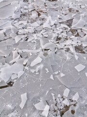 Fragments of broken ice close up. Winter textured natural background.