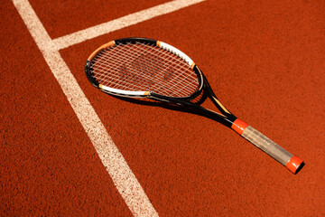 a broken tennis racket blue tennis court.