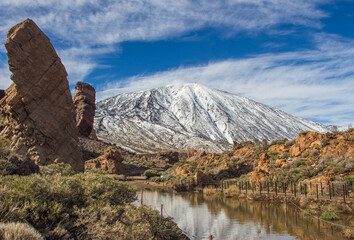 Teide volcano with snow in winter with the rocks. Snowy mountain. Mountain landscape in winter. Snowy mountain in the background. Snowy mountain in the background.Tenerife, Canary Islands, Spain.