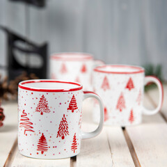 coffee cups with christmas decoration on a white table