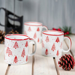 coffee cups with christmas decoration on a white table