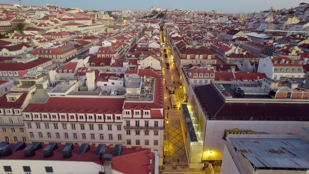 Lisbon downtown aerial view, flying above European capital city, famous Commerce square at sunset, tourism in Portugal