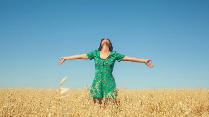 woman breathing fresh air with an azure blue sky in the background. Woman breathing fresh air with...