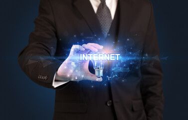 Businessman holding a light bulb