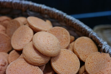 A lot of round-shaped cookies are piled up.