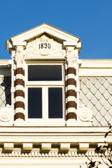 Dormer of a historic house in Utrecht in the Netherlands with a clear blue sky