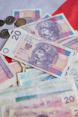 Obraz premium Polish money zloty banknotes on the Polish flag