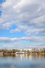 Fototapeta premium Landscape with large old trees near Herastrau lake in King Michael I Park (Herastrau) in Bucharest, Romania, in a sunny winter day