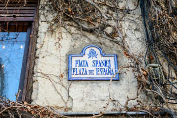 Beautiful vintage street sign showing Piata Spania (Spain Square or Plaza de Espana) displayed on an old building in city center of Bucharest, Romania - obrazy, fototapety, plakaty