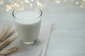 Glass of milk on wooden background and bokeh of light ,Concept of farm dairy products with copy space.
