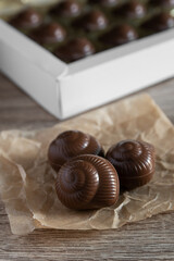 Praline milk chocolate snails on the table