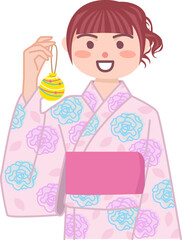 水風船を持っている笑顔の浴衣女性