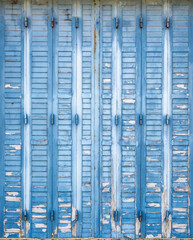 Weathered blue paint wooden shutters
