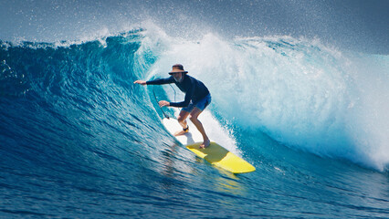 Senior surfer rides the ocean wave - obrazy, fototapety, plakaty