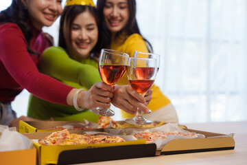 Happy young asian people friends group meeting office pizza party, laughing enjoying meal together celebration holiday and togetherness after working on new year.
