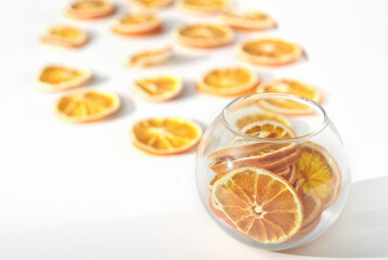  dry oranges in a vase and on a table for holiday decor. dried fruits as natural house decoration.