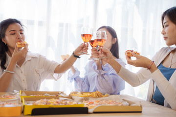 Cheers, Group of young asian office girl friends having fun and celebrating pizza on table during party