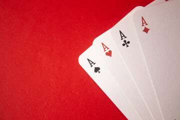 Four aces on red background. playing cards