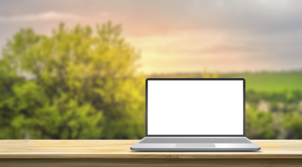 3d illustration, mock-up of a laptop standing on the wooden desk against the blurred nature background, blank screen with copy space