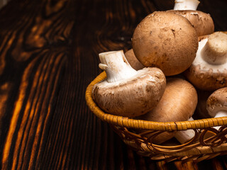 mushrooms in a basket on wooden table