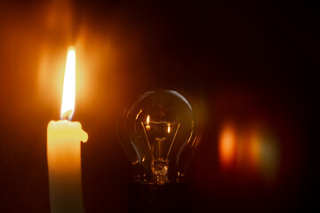 candle light and bulb in the dark room
