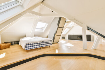 an attic bedroom with wood flooring and skylights above the bed, as well as it is in this photo