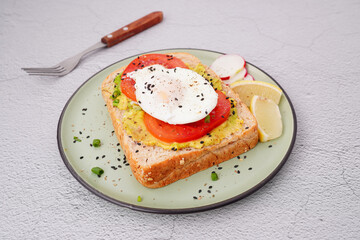 Breakfast, avocado on wholemeal bread and boiled egg on white background