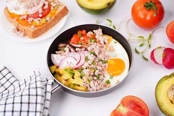 Breakfast fried eggs in a pan on a white background
