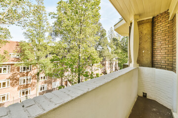 an apartment balcony with trees and buildings in the background on a bright sunny day photo taken...