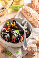 Aromatic and spicy mussels served with white wine.