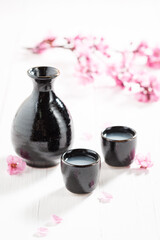 Obraz na płótnie Canvas Strong Japanese sake in small black ceramics.