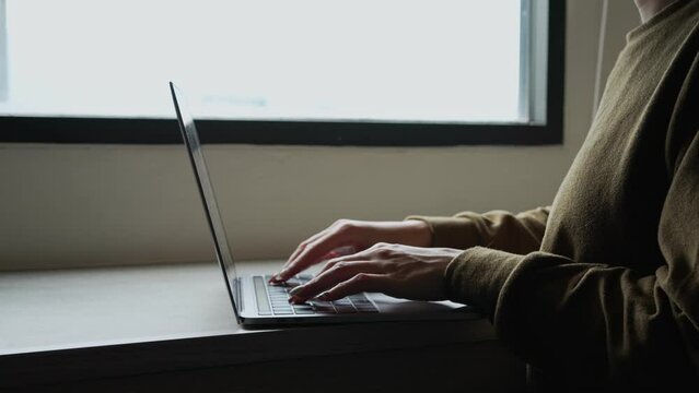 Woman uses modern laptop touchpad or trackpad with her hand. For search data on internet. work from home concept.