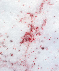 Drops of blood on white snow